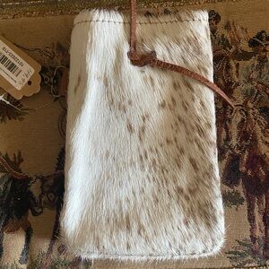 This is a cowhide leather pouch. Great for holding a wine bottle.